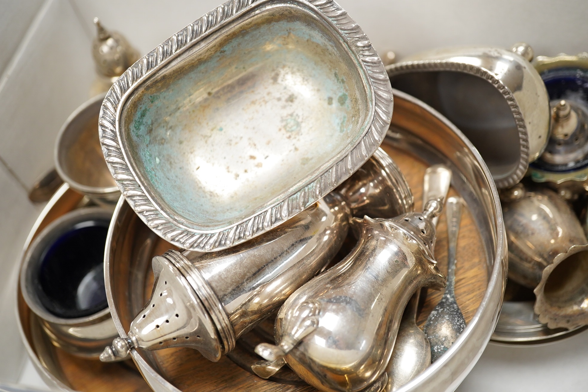 A pair of modern silver decanter coasters, London, 1973 and a collection of silver condiments etc. Condition - poor to fair